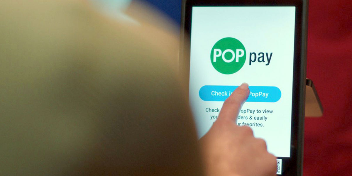 Person using tablet with POP Pay on the screen
